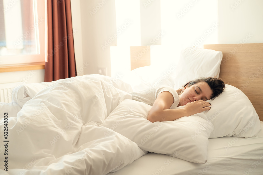 Young beautiful alone woman sleeping on bed in bedroom Young beautiful alone woman sleeping on bed in bedroom