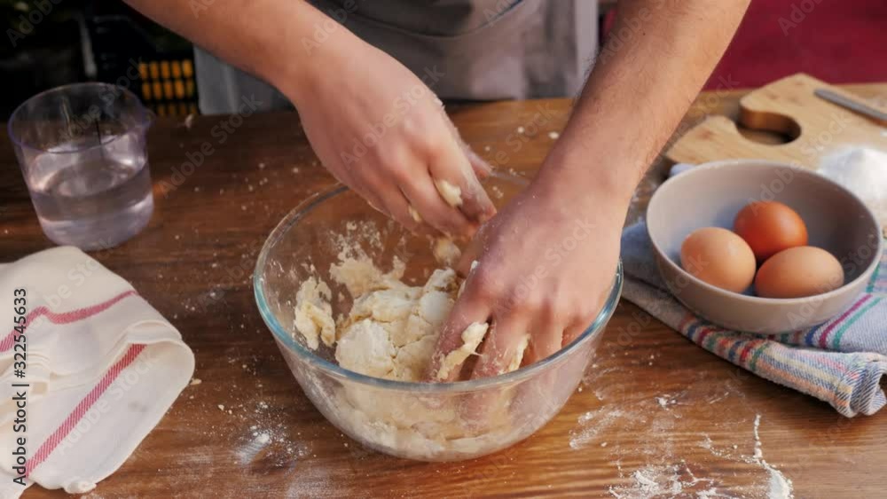 Hands kneading raw dough on table flat lay. Top view on baker with empanadas cooking on table. Culinary, cooking, bakery concept Hands kneading raw dough on table flat lay. Top view on baker with empanadas cooking on table. Culinary, cooking, bakery concept