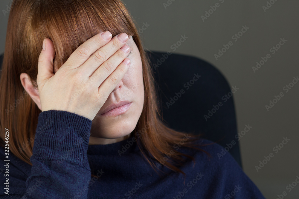 Portrait of middle aged woman holding hand on eyes Portrait of middle aged woman holding hand on eyes