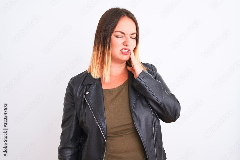Young beautiful woman wearing t-shirt and jacket standing over isolated white background touching mouth with hand with painful expression because of toothache or dental illness on teeth. Dentist Young beautiful woman wearing t-shirt and jacket standing over isolated white background touching mouth with hand with painful expression because of toothache or dental illness on teeth. Dentist