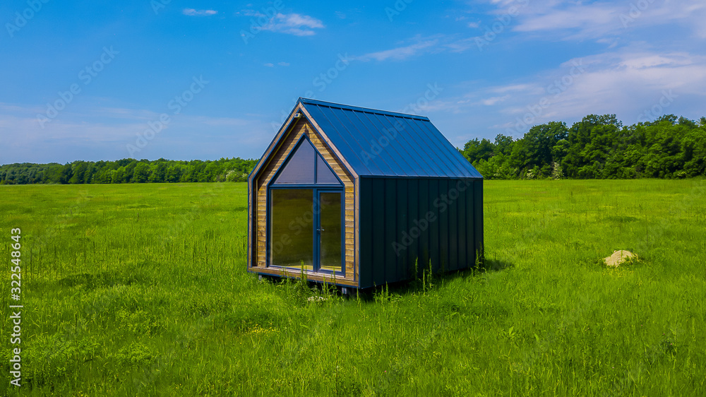 Modern one-story house in the middle of a green field Modern one-story house in the middle of a green field