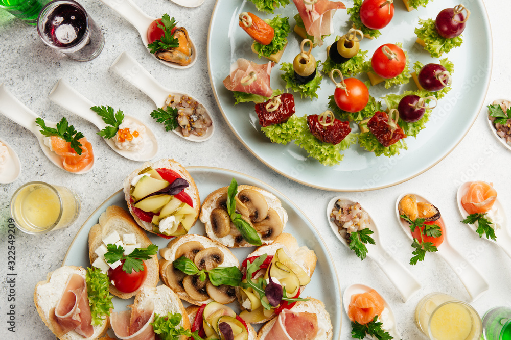 portioned snacks canapes and sandwiches with meat, cheese and vegetables portioned snacks canapes and sandwiches with meat, cheese and vegetables