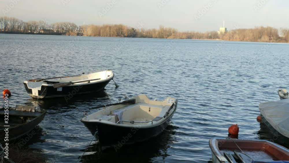 Small Rowing Boats Floating close to the Shore of a Lake Small Rowing Boats Floating close to the Shore of a Lake