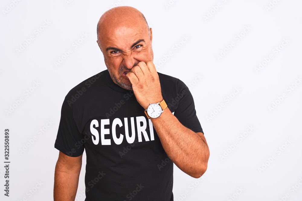 Middle age safeguard man wearing security uniform standing over isolated white background looking stressed and nervous with hands on mouth biting nails. Anxiety problem. Middle age safeguard man wearing security uniform standing over isolated white background looking stressed and nervous with hands on mouth biting nails. Anxiety problem.