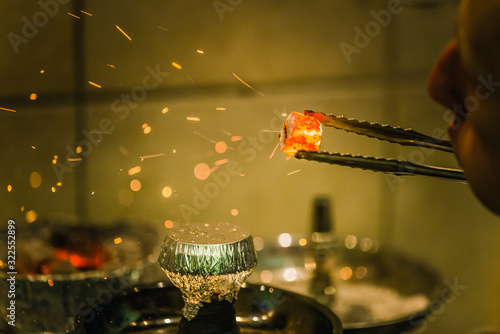 The process of burning shisha. Strong close-ups, colorful frames with lots of smoke. The dynamics of sparks.