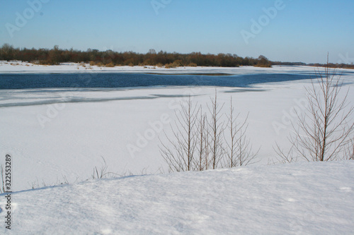 Fototapeta Naklejka Na Ścianę i Meble -  frozen river and forest in spring