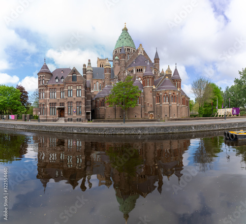 The St Bavo cathedral in Haarlem city reflected in the Leidsevaart