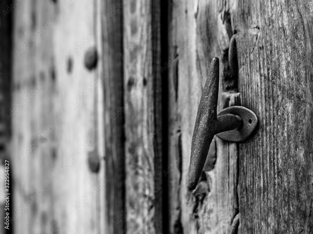 Detail of the doorknob or handle of an old vintage door - Black and White revealed. Talavera de la Reina Detail of the doorknob or handle of an old vintage door - Black and White revealed. Talavera de la Reina