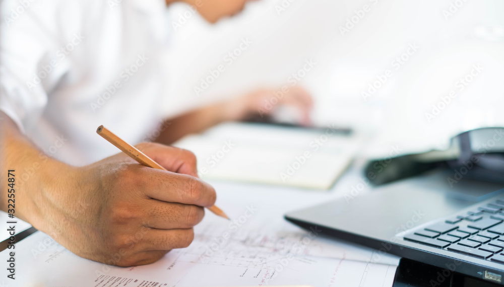 Structural design engineers work in building structure analysis.Closeup video Insturments and office for designer.drawings and computer on the table.Heavy industry business Concept Construction Structural design engineers work in building structure analysis.Closeup video Insturments and office for designer.drawings and computer on the table.Heavy industry business Concept Construction