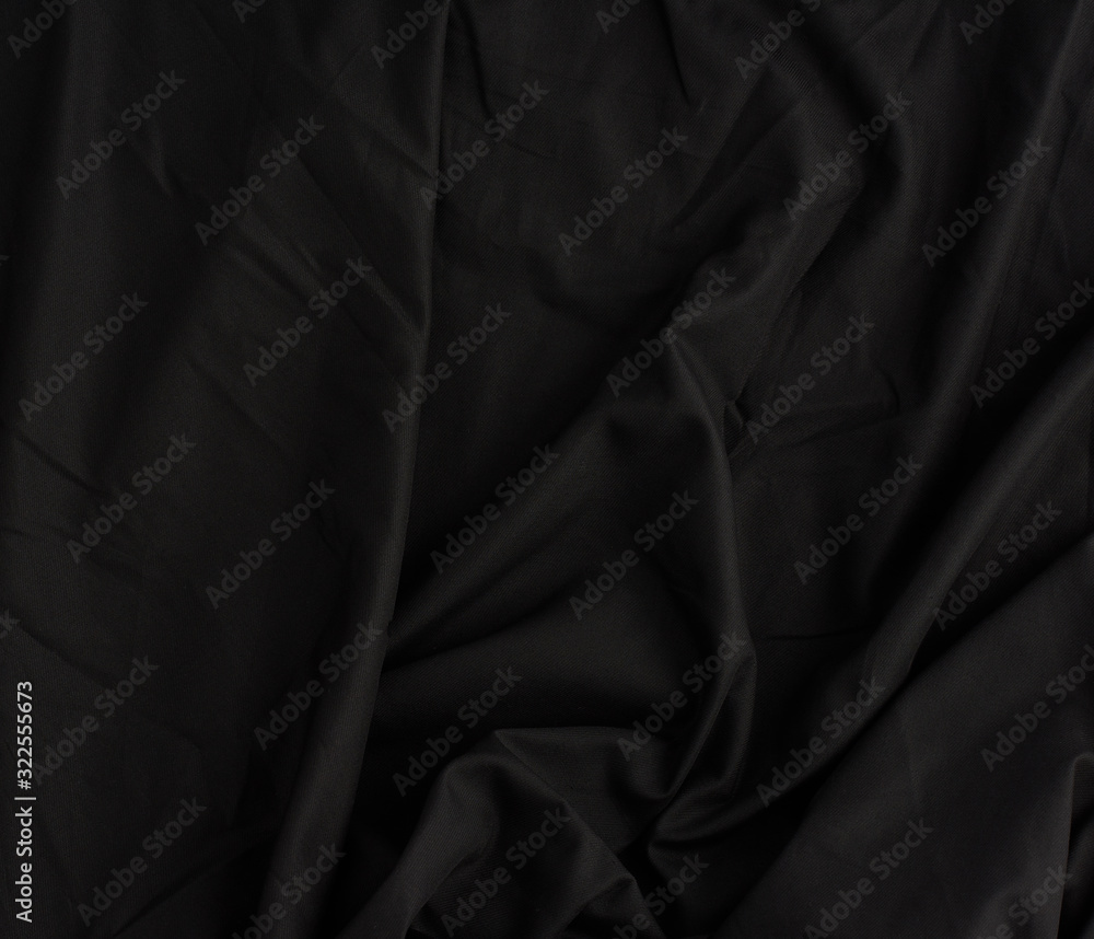 texture of black cotton fabric with waves, full frame