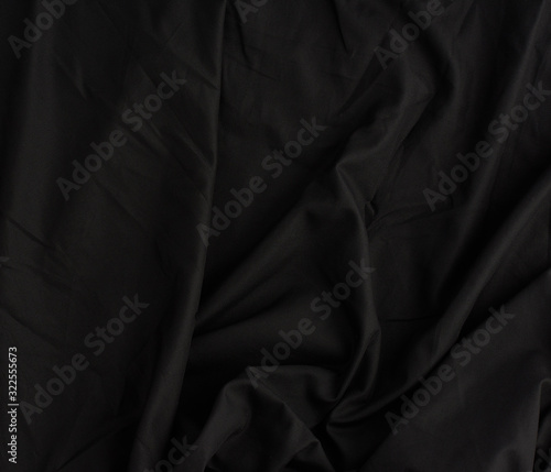 texture of black cotton fabric with waves, full frame