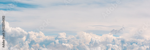 Banner 3:1. Blue sky with fluffy clouds. Aerial view from airplane window © thayra83