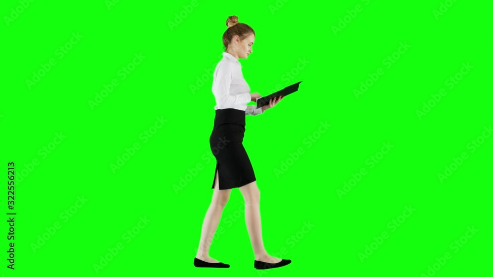 Elegant Office Worker Looks Through Documents on Green Screen When Walking Elegant Office Worker Looks Through Documents on Green Screen When Walking