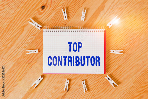 Handwriting text writing Top Contributor. Conceptual photo demonstrating who is knowledgeable in a particular category Colored clothespin papers empty reminder wooden floor background office