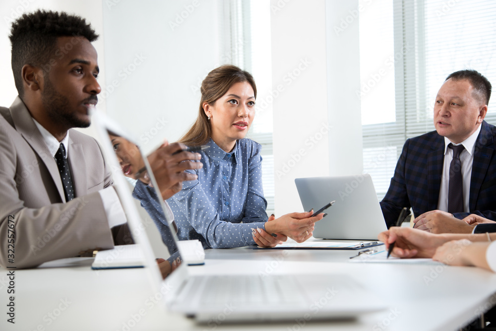 Multy-ethnic group of business people working with computer at office Multy-ethnic group of business people working with computer at office