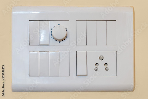 Fotografia Modern modular switchboard with on/off switch, 3 pin socket and fan regulator