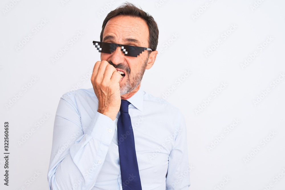 Middle age businessman wearing thug life sunglasses over isolated white background looking stressed and nervous with hands on mouth biting nails. Anxiety problem.