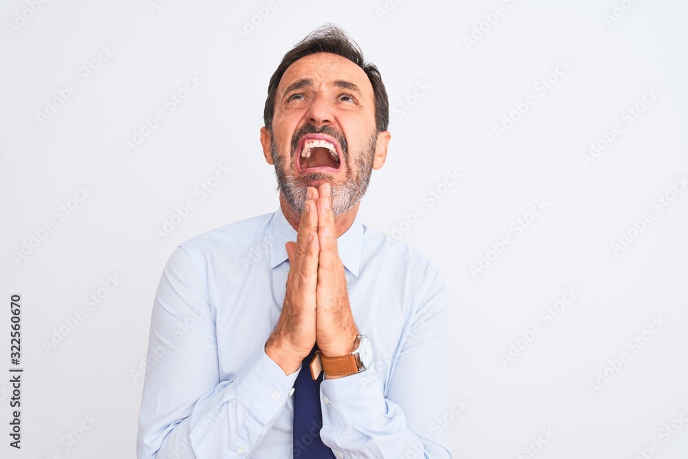 Middle age businessman wearing elegant tie standing over isolated white background begging and praying with hands together with hope expression on face very emotional and worried. Asking for Middle age businessman wearing elegant tie standing over isolated white background begging and praying with hands together with hope expression on face very emotional and worried. Asking for