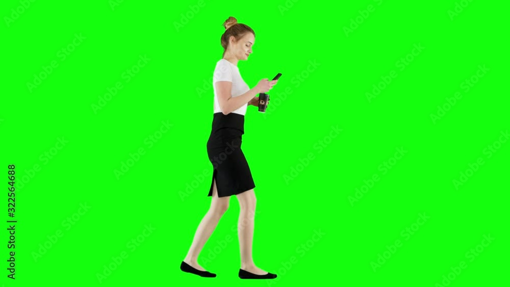 Happy Businesswoman Using a Smartphone Drinking Coffee Walking on Greeen Screen Happy Businesswoman Using a Smartphone Drinking Coffee Walking on Greeen Screen