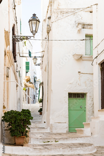 white houses, small alley with stairs in Ostuni, Italy © Corinne