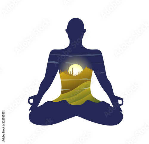 Monk silhouette practising yoga lotus pose, morning bright sun in heart chakra and mountain landscape.