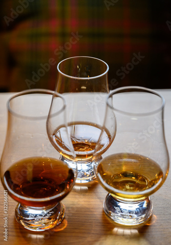 Fototapeta Naklejka Na Ścianę i Meble -  Flight of Scottish whisky, tasting glasses with variety of single malts or blended whiskey spirits on distillery tour in Scotland