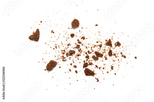 Scattered crumbs of chocolate cookies isolated on white background.