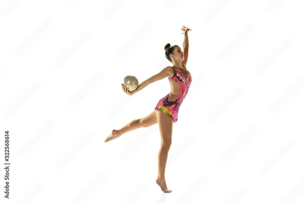Obraz premium Young flexible girl isolated on white studio background. Teen-age female model as a rhythmic gymnastics artist practicing with equipment. Exercises for flexibility, balance. Grace in motion, sport.