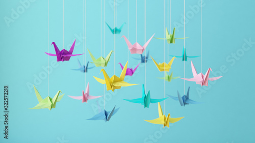 3D illustration-Colorful pastel origami paper cranes on blue background.