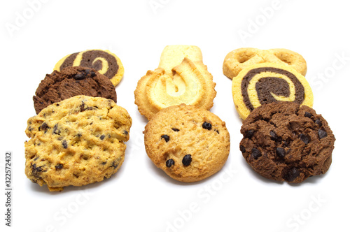 Stack of assorted cookies. Chocolate chip, oatmeal, raisin, Danish cookies and biscuits in the shape of a spiral pattern isolated on white background. © Inkanya