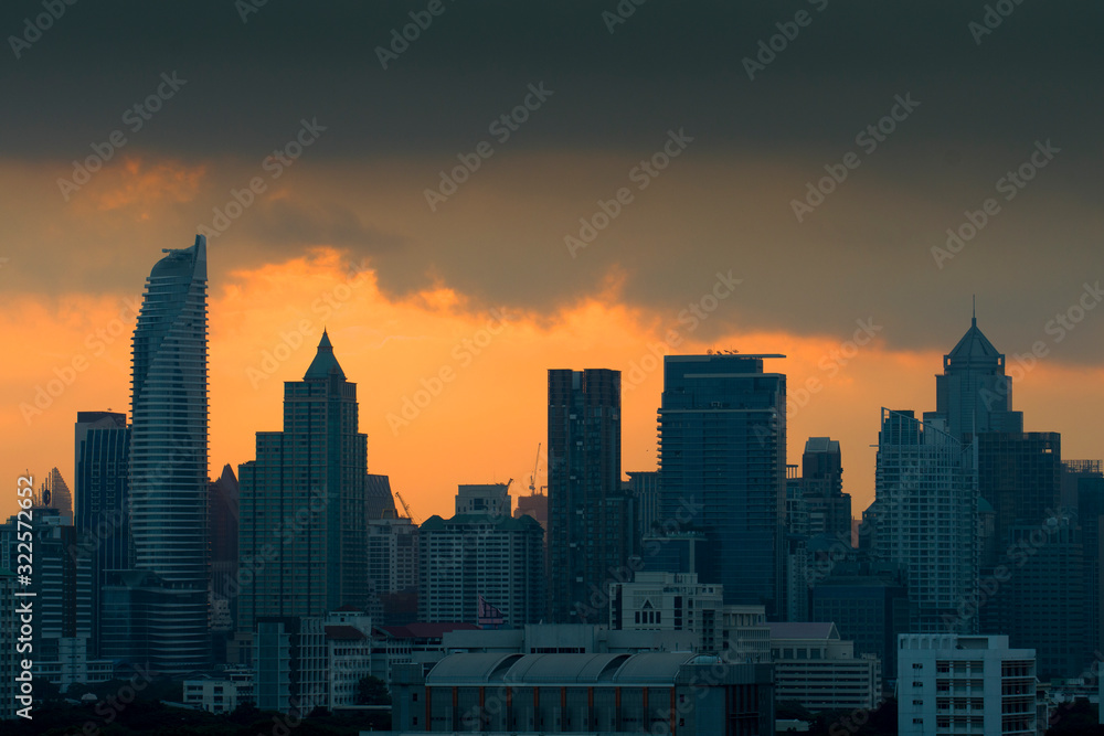 Silhouette of City skyline while sunset in downtown district at Bangkok.