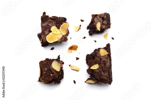 Chocolate brownie with sliced almond nuts toppings broken and crumbs isolated on white background.