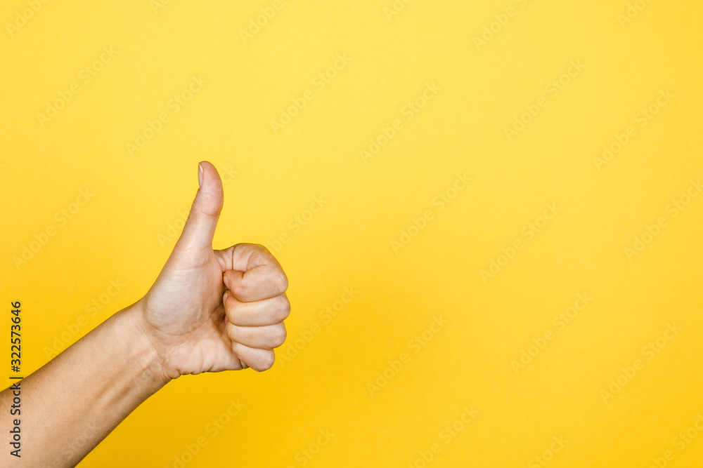 like. big thumb up on yellow background with copy space for modern designs