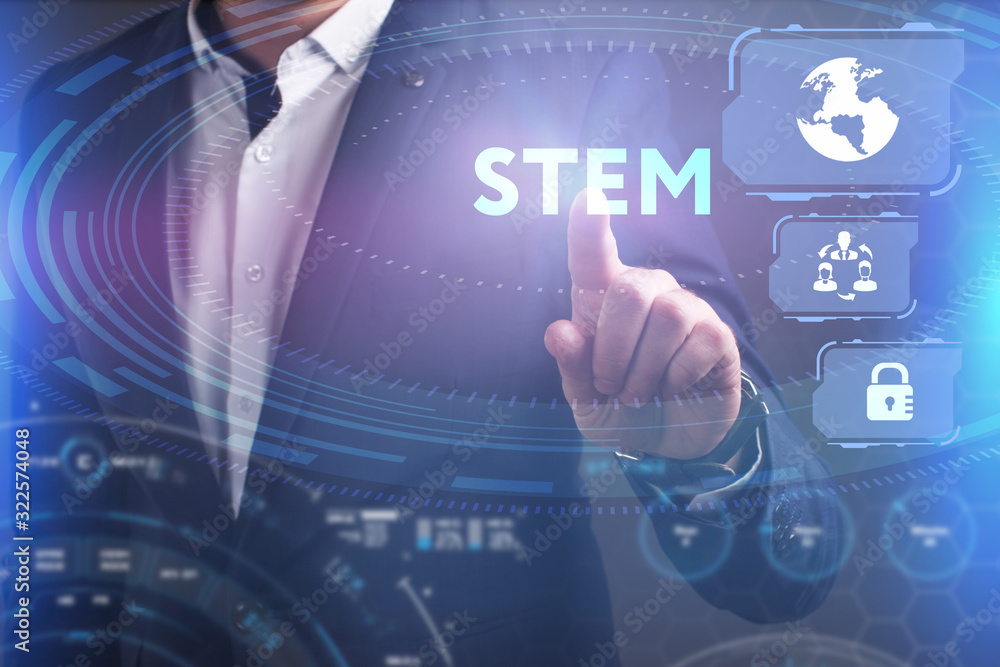 Business, Technology, Internet and network concept. Young businessman working on a virtual screen of the future and sees the inscription: STEM Business, Technology, Internet and network concept. Young businessman working on a virtual screen of the future and sees the inscription: STEM