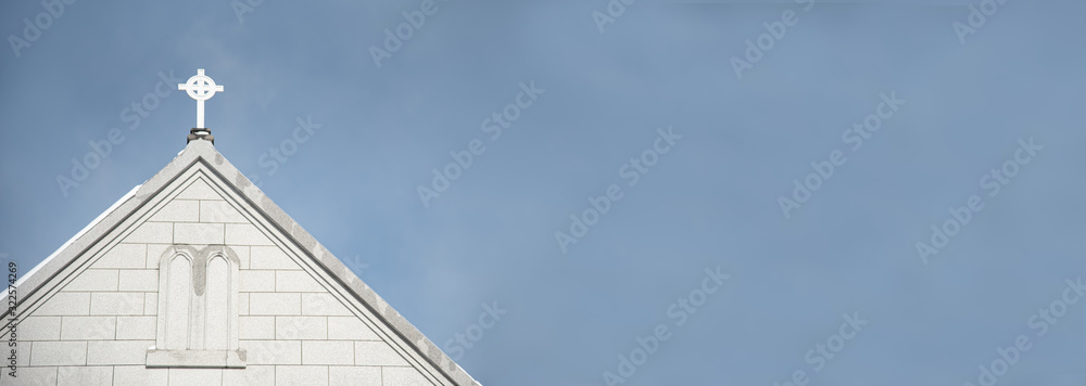 Christian church with crucifix cross on a rooftop.