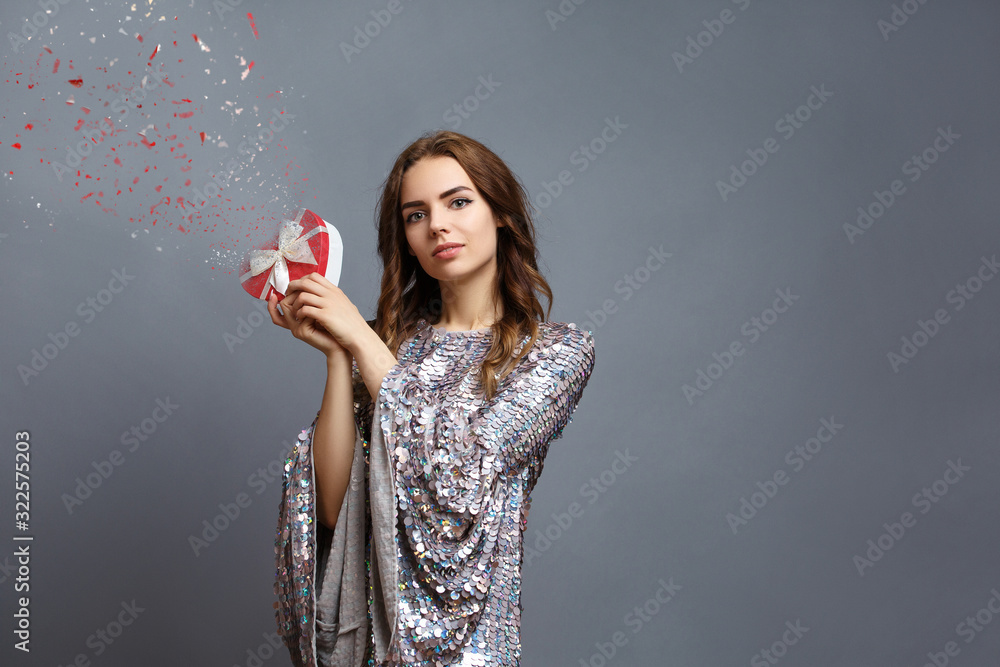 girl in shiny dress with gift box girl in shiny dress with gift box