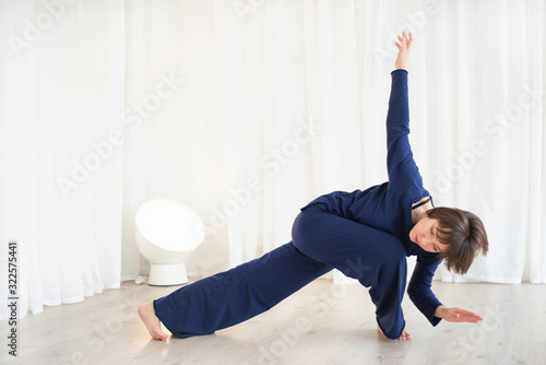 Woman doing exercises in a white room photo