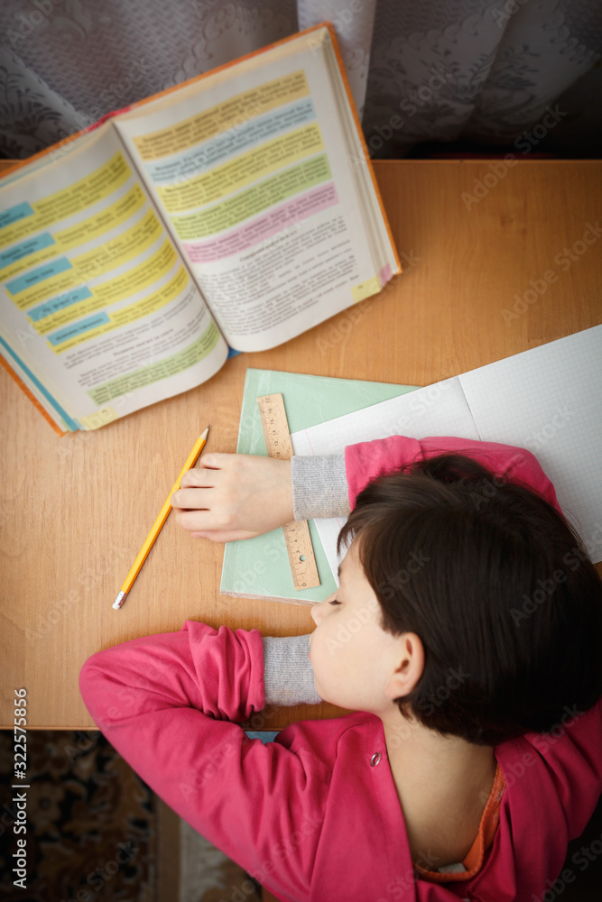 Little schoolgirl fell asleep at school homework. Little schoolgirl fell asleep at school homework.