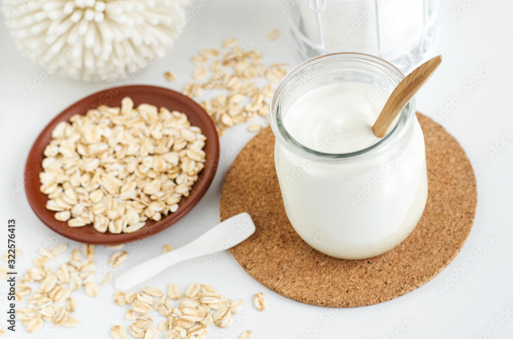 Homemade greek yogurt and oatmeal face mask in the glass jar. Diy natural beauty treatment recipe. Copy space Homemade greek yogurt and oatmeal face mask in the glass jar. Diy natural beauty treatment recipe. Copy space