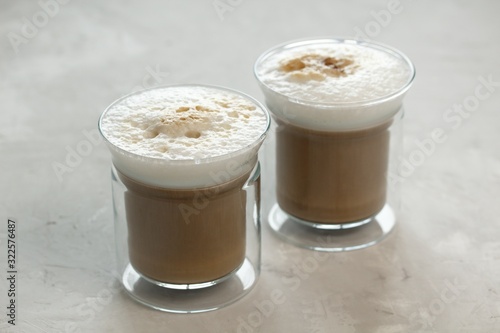 Two glass cups with latte coffee