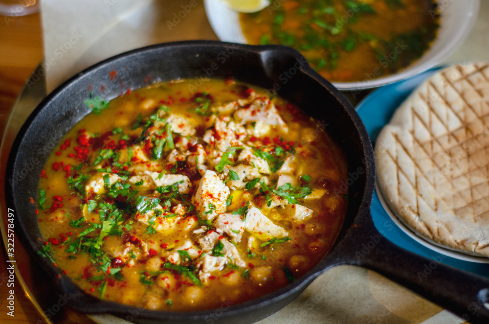 Shurpa with chicken and chickpeas in a pan. Israeli cuisine