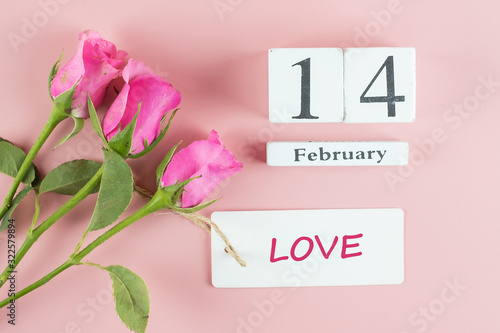 Fototapeta Naklejka Na Ścianę i Meble -  Pink rose flower and 14th February Calendar on pink background. Love, Romantic and Happy Valentines day Holiday concept