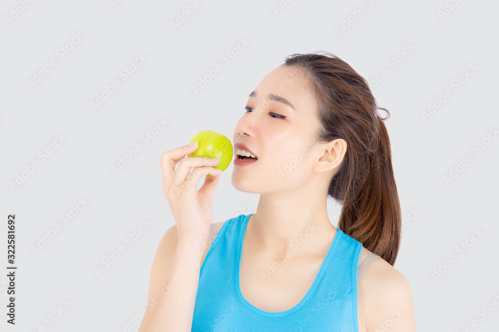 Beautiful portrait young asian woman in sport with satisfied and holding and eat green apple isolated on white background, girl asia have shape and wellness, exercise for fit with health concept. Beautiful portrait young asian woman in sport with satisfied and holding and eat green apple isolated on white background, girl asia have shape and wellness, exercise for fit with health concept.