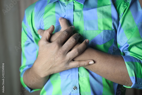 young man suffering heart pain, heart attack risk concept 