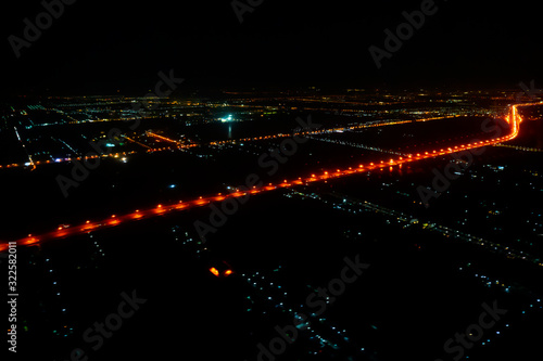 A view looking down on the city from the air at night plane thailand