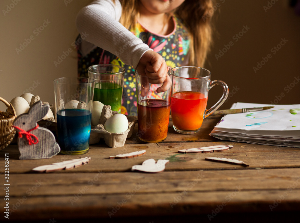 little girl paints easter eggs/easter background little girl paints easter eggs/easter background