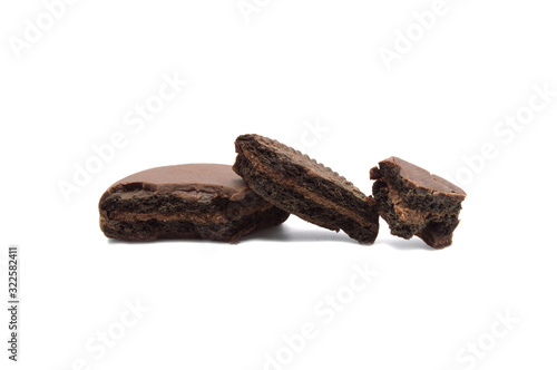 Chocolate sandwich cookies filled and coated with chocolate cream isolated on white background.
