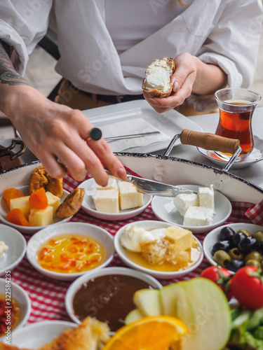 Fototapeta Naklejka Na Ścianę i Meble -  Classic turkish breakfast with different types of cheese. Butter on bread