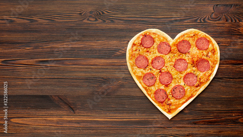 Lovely arrangement for valentines day dinner with heart shaped pizza and copy space