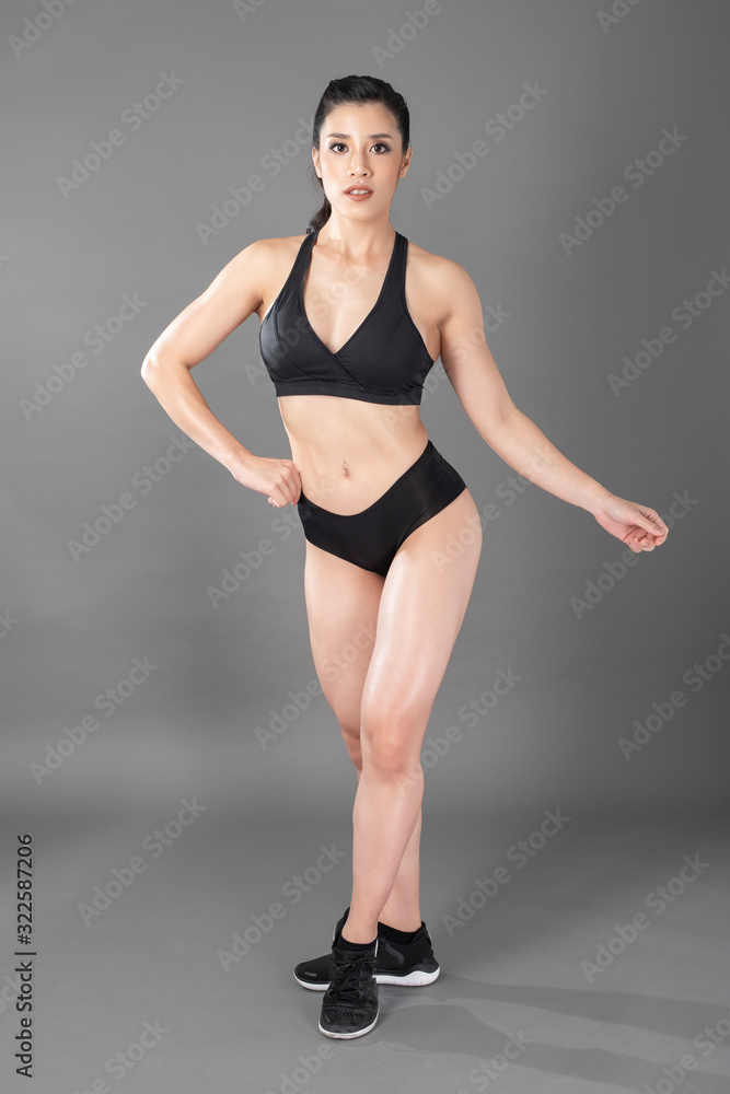 Beautiful fitness body builder woman in Studio